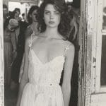 Woman in lace dress standing in doorway