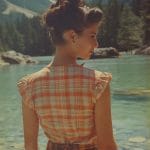 Woman in plaid shirt near clear mountain lake