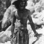 Shirtless man with hat and accessories