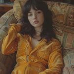 Person in yellow outfit on patterned couch