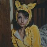 Person wearing Pikachu costume in indoor setting.