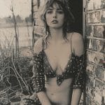 Woman in star-patterned outfit by brick building