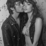 Stylish couple posing in leather jackets.