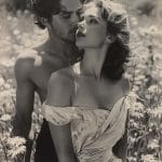 Romantic couple embracing in wildflower field