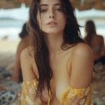 Woman in floral dress at sunny beach