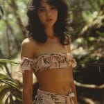 Woman in floral off-shoulder outfit, tropical background