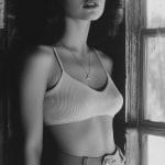 Black and white portrait by a window