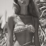 Woman in patterned bikini posing outdoors.