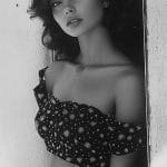 Black and white portrait of a woman in dress.