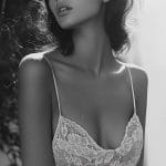 Black and white photo of woman in lace dress.