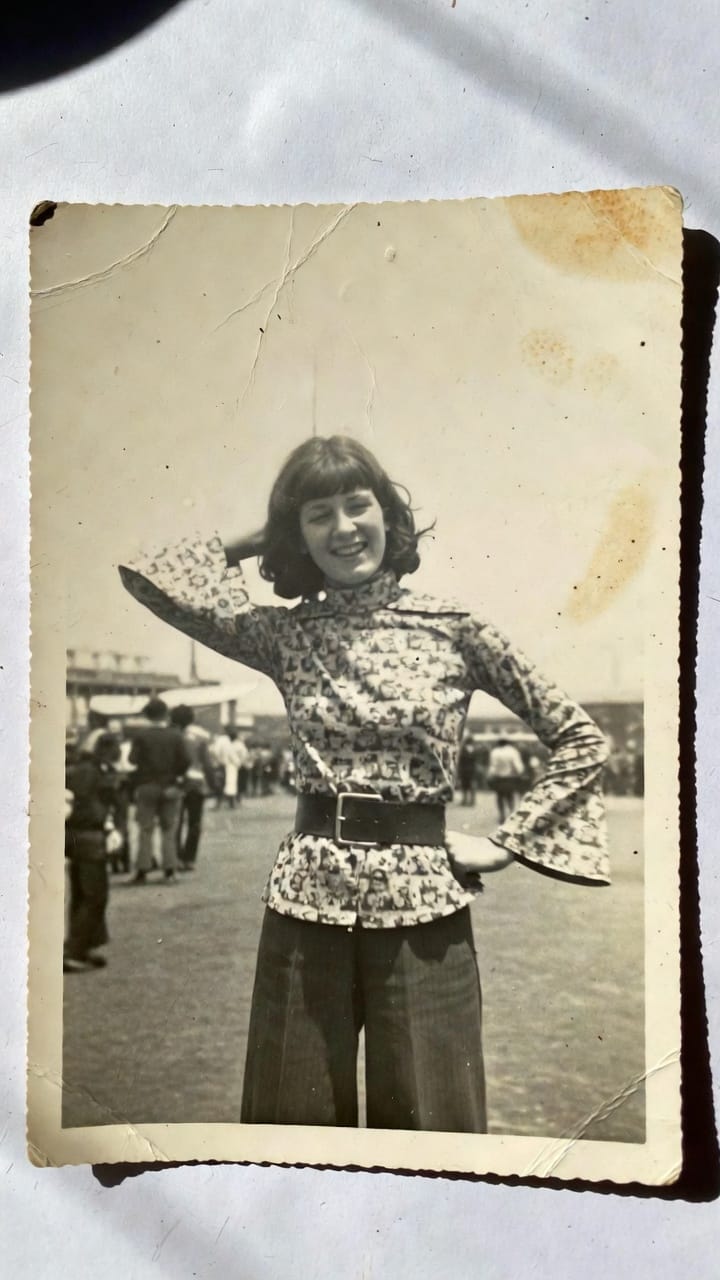 Vintage photo of smiling woman posing outdoors