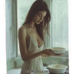 Woman cooking in a kitchen with natural light.