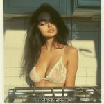 Woman in lace top by kitchen stove.