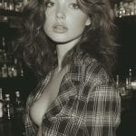 Sepia portrait of woman in plaid shirt.