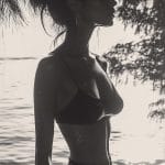 Silhouette of woman by the beach at sunset.