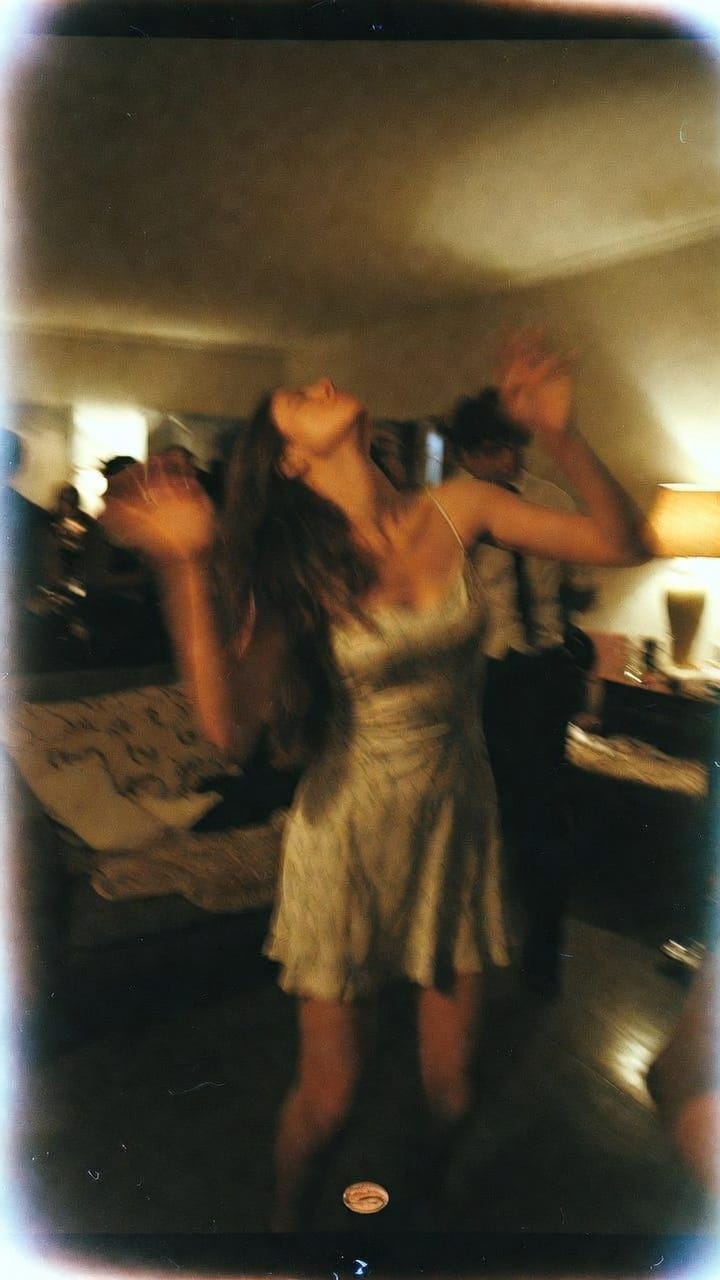 Woman dancing at dimly lit house party