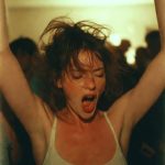 Woman dancing energetically with arms raised at party