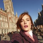 Woman taking selfie in historic European city square
