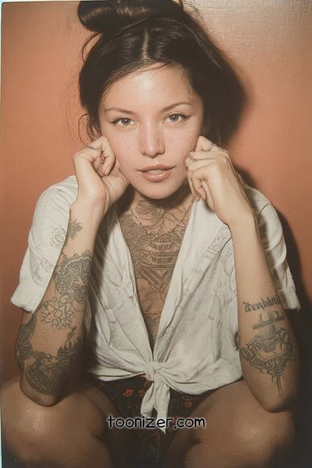 Person with tattoos posing on orange background.