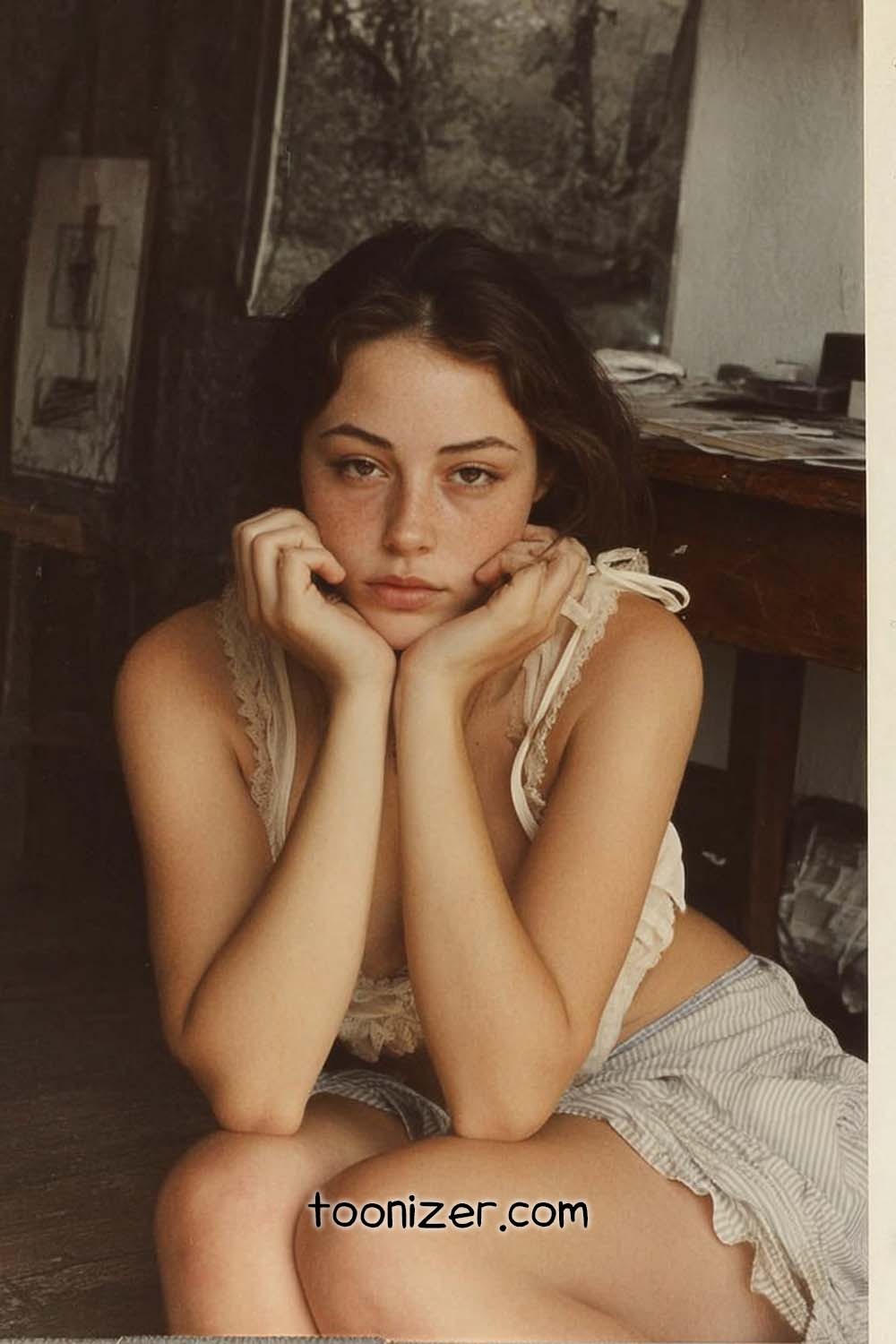 Young woman resting chin on hands indoors