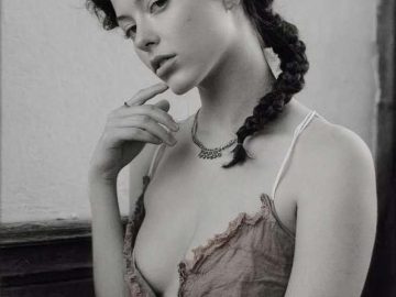 Woman with braided hair in vintage style.