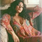 Woman relaxing in colorful bohemian dress