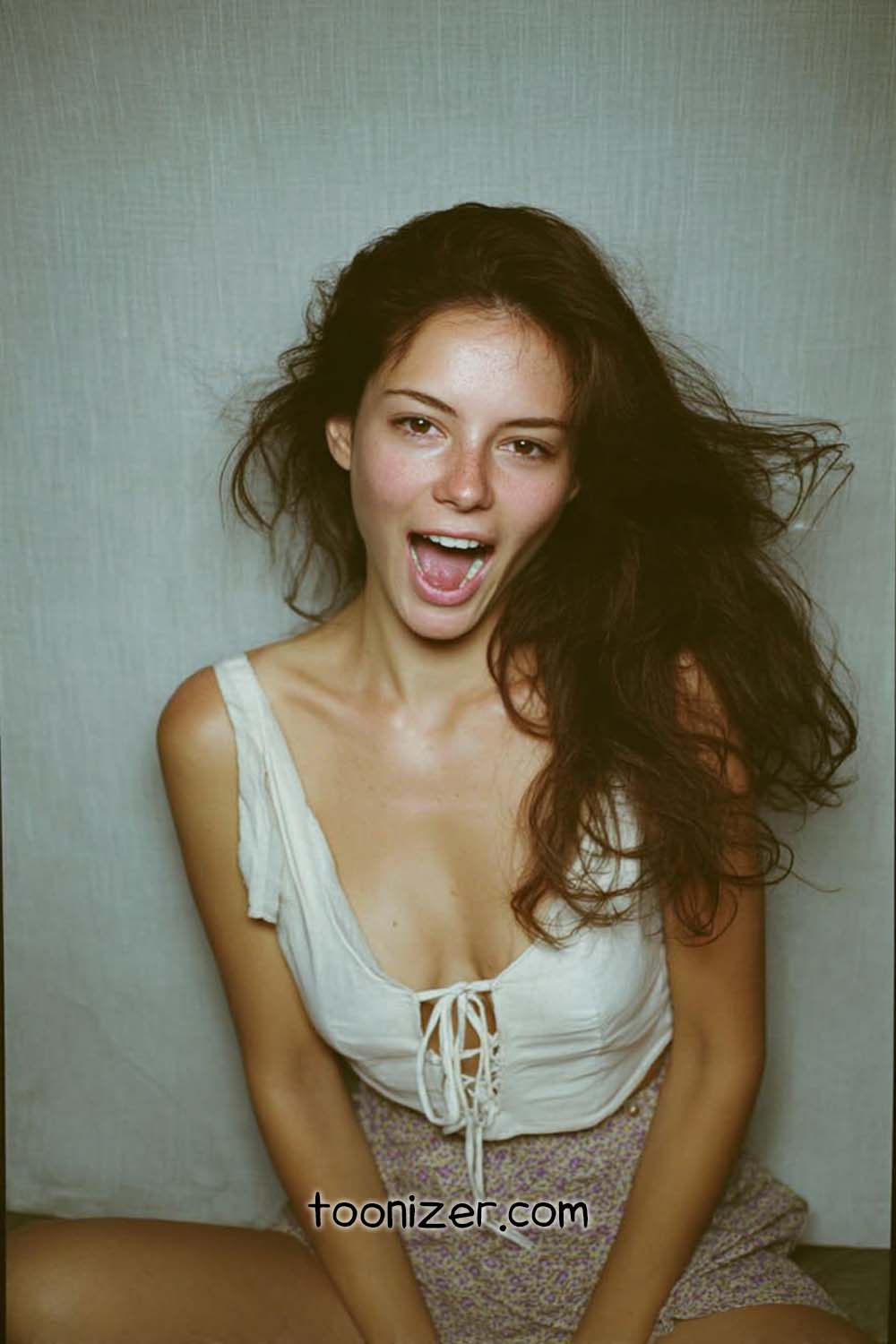 Smiling woman with open mouth, playful expression.