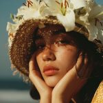 Woman with floral hat in sunlight