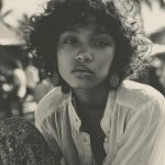 Portrait of a person in tropical setting.