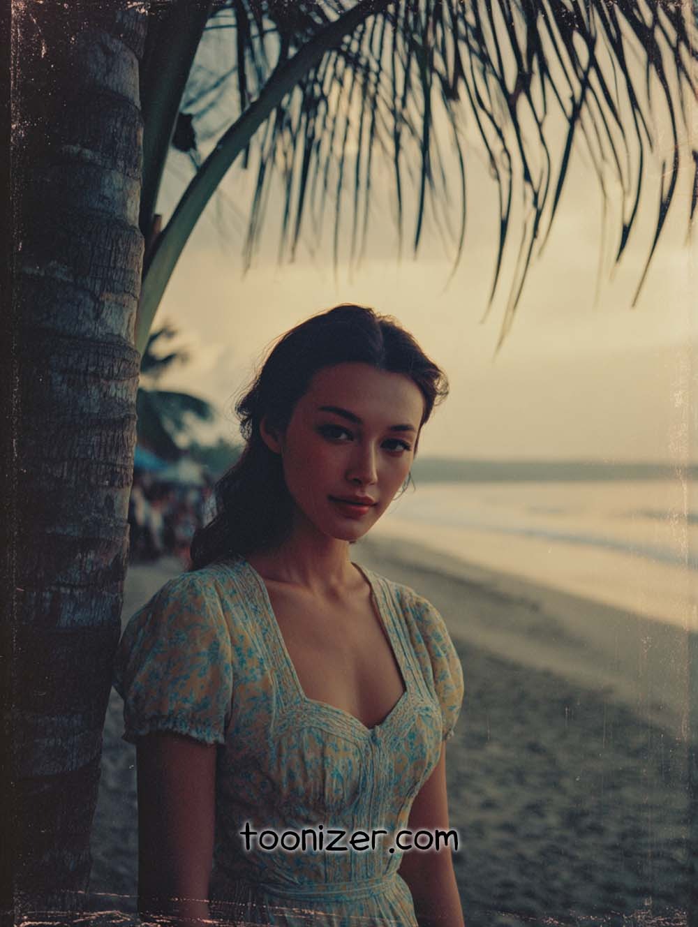 Woman standing by palm tree on beach