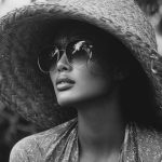 Woman in large sun hat and sunglasses