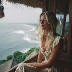 Woman gazing at ocean view from window