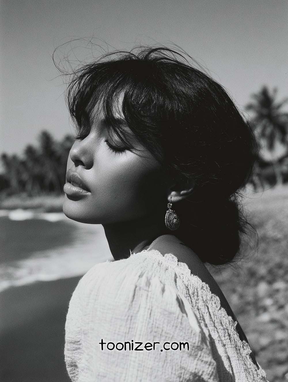 Woman enjoying seaside breeze in black and white