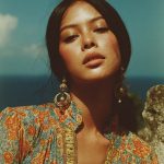 Woman in floral dress under sunny sky