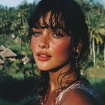 Woman in tropical setting with lush background