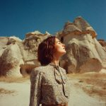 Woman enjoying sunny day in rocky landscape.