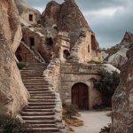 Ancient stone structure in rocky landscape.