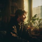 Man sitting by window in warm light