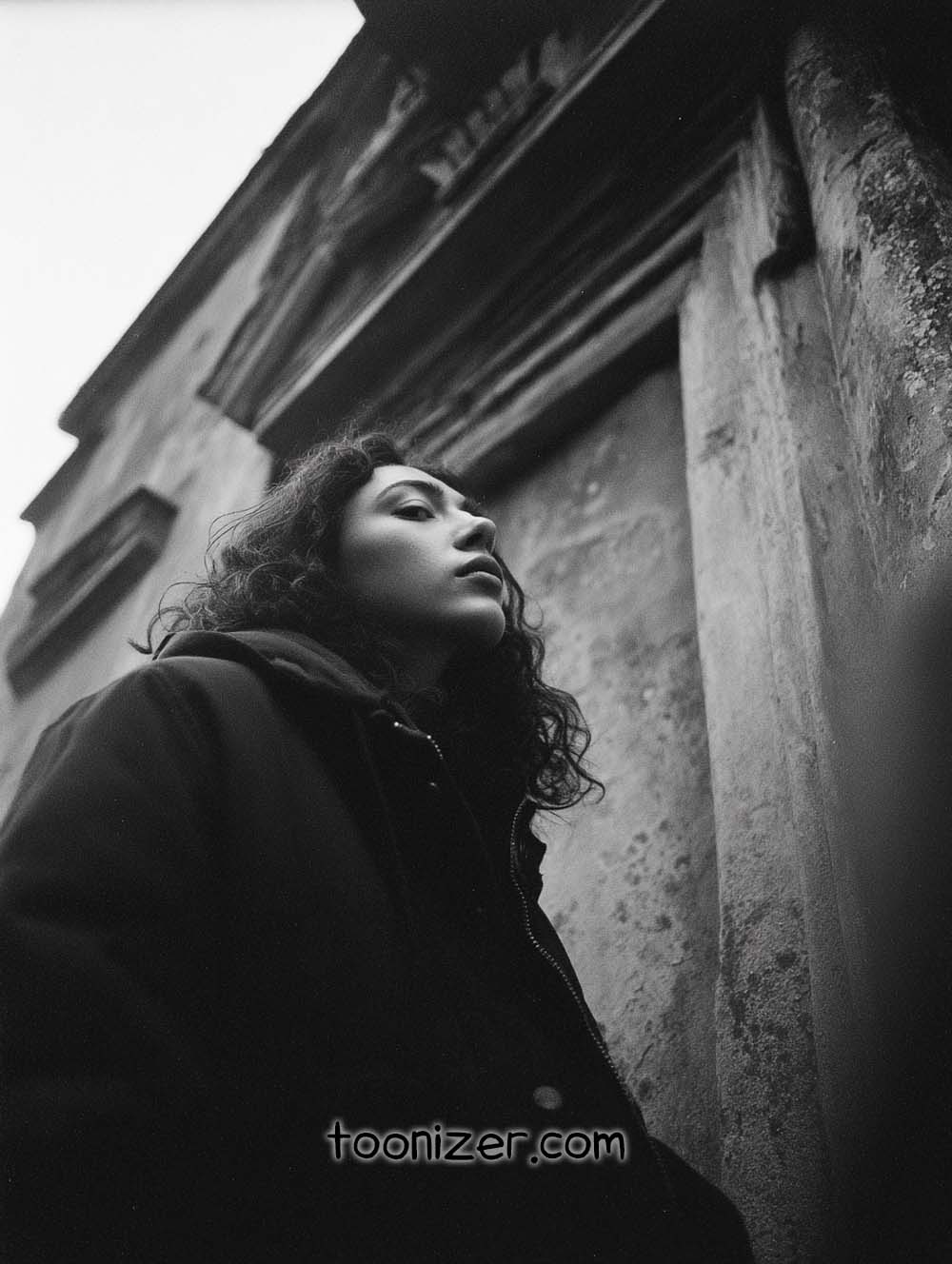 Woman in black and white, looking upwards