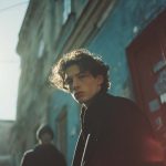 Stylish person in urban setting, moody lighting