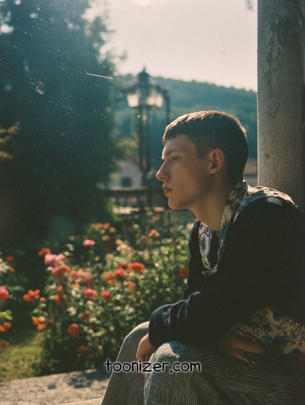Person sitting in garden during sunset.