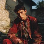 Person in traditional ornate red attire outdoors