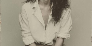 Vintage portrait of woman in white shirt.