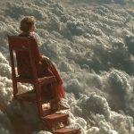 Woman on chair overlooking clouds and stairs