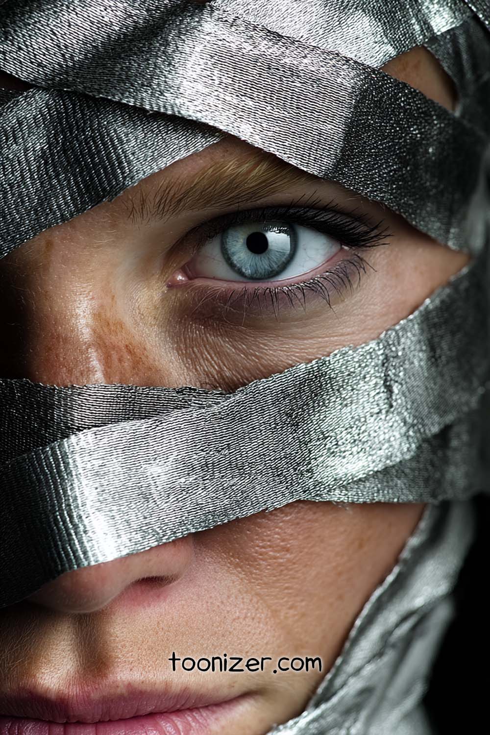 Close-up of eye with metallic ribbons.