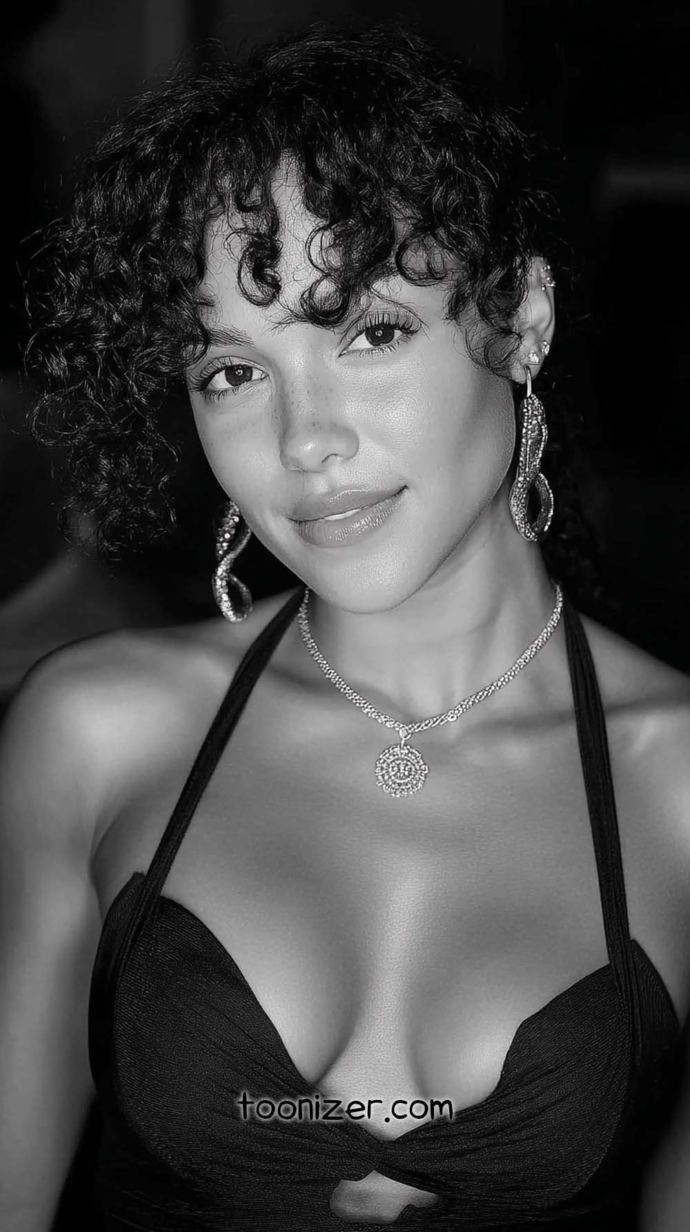 Smiling person with curly hair and jewelry