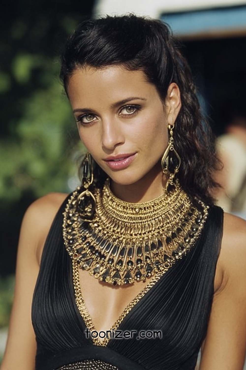 Woman wearing ornate gold statement necklace.