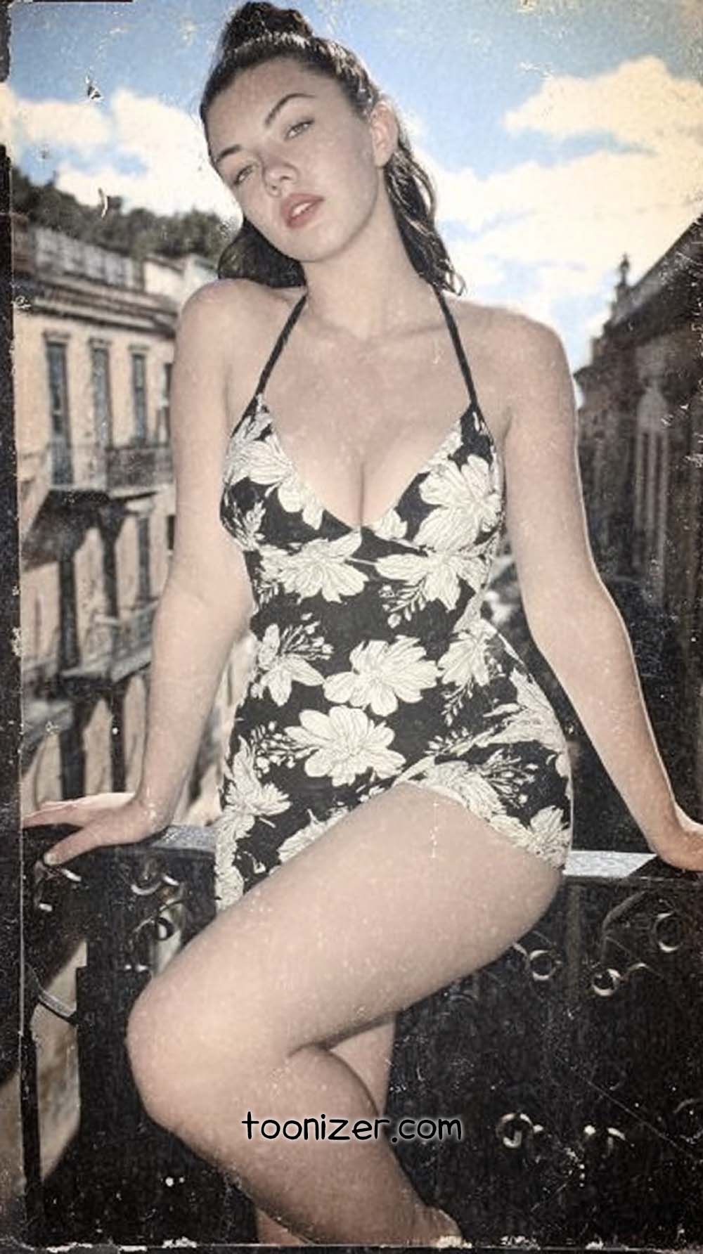 Woman in floral dress on balcony