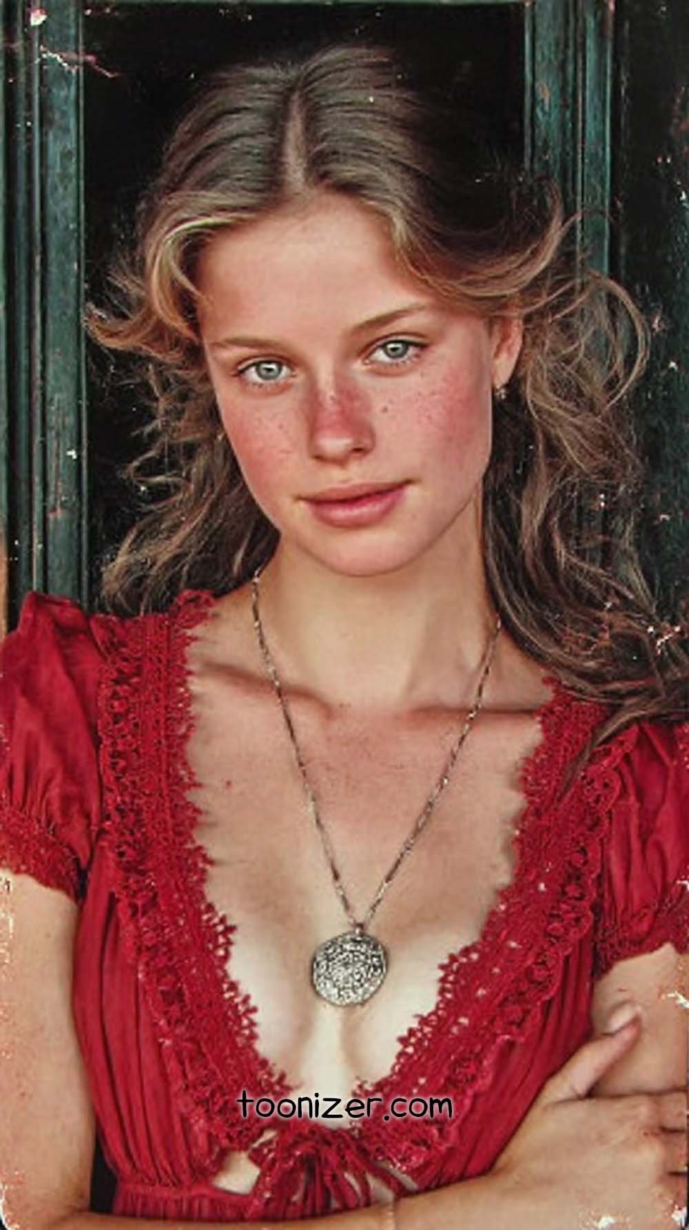 Woman in red dress with necklace.