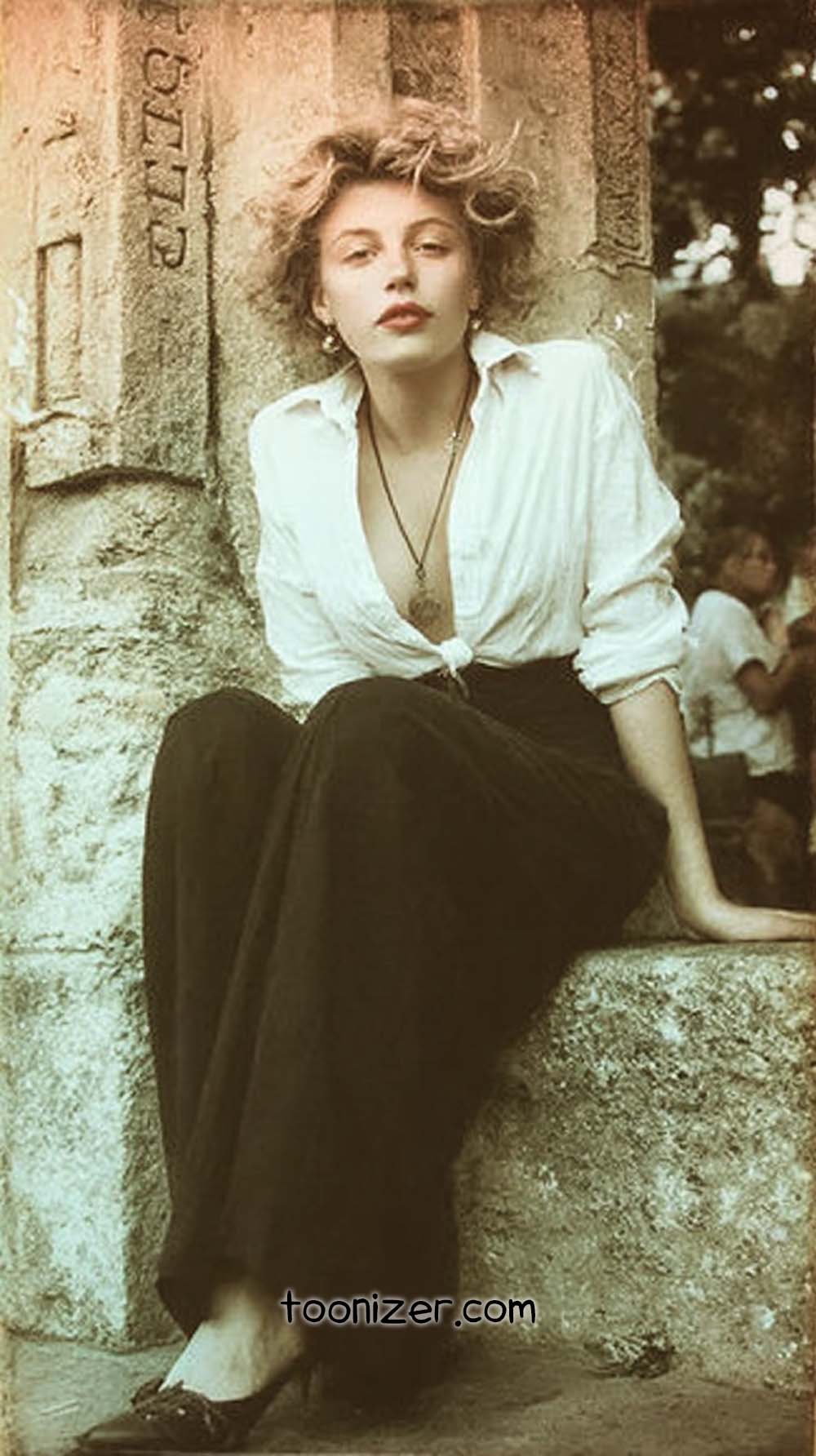 Vintage style portrait of a woman sitting outside.